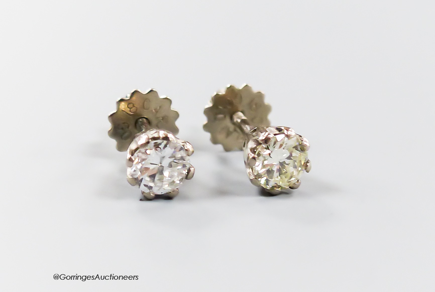 A pair of modern 18ct and solitaire diamond set ear studs, the stones each weighing approximately 0.30ct, gross weight 1.6 grams.